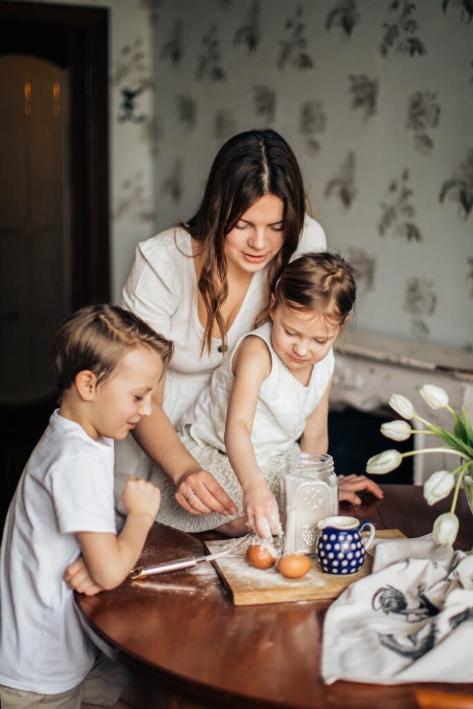 A joyful mother and her two children baking together at home, enjoying quality family time.